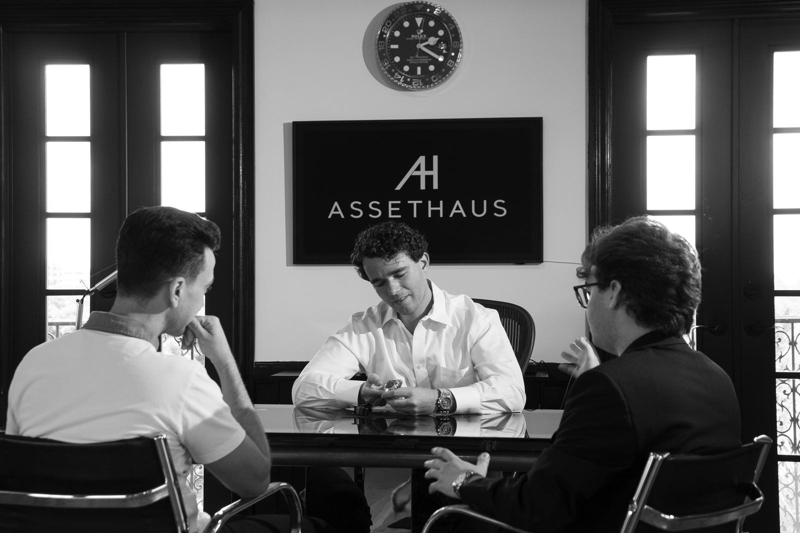 A watch being examined across the table at the ASSETHAUS office
