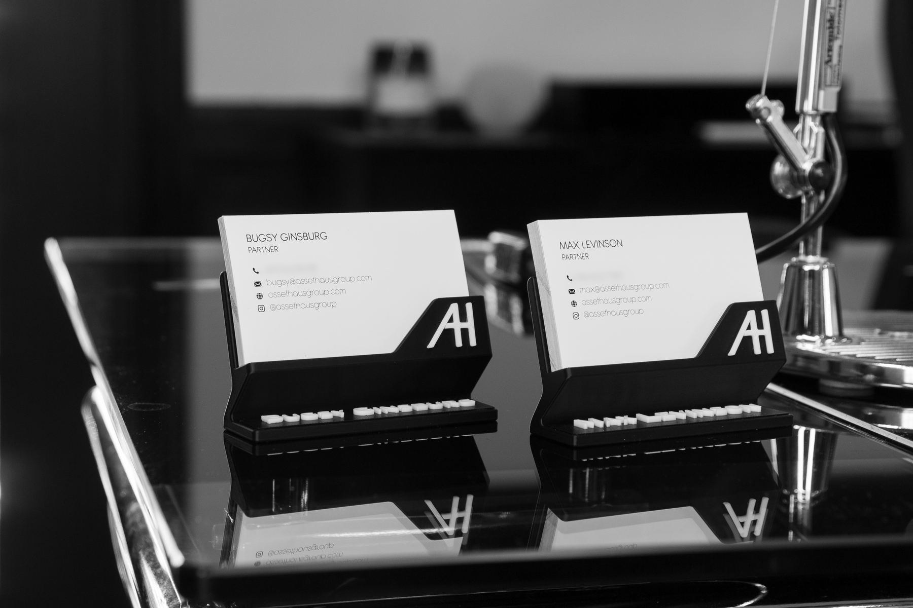ASSETHAUS business cards on the desk
